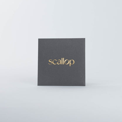 Black square box with gold 'scallop' text on a white background.