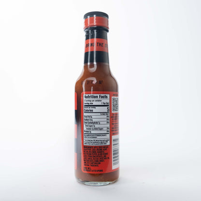 The back label of a Murder Hornet hot sauce bottle showing ingredients and a barcode on a red background.